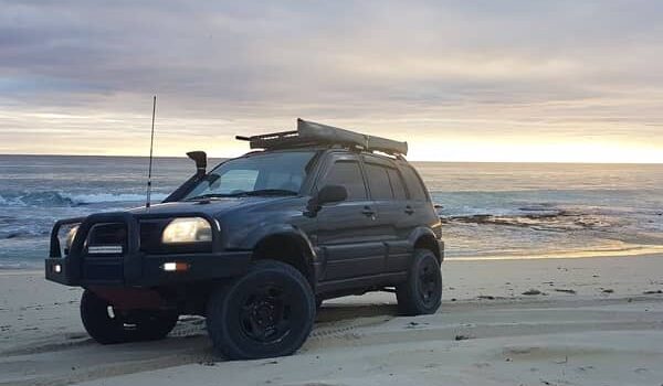 black suzuki grand vitara on beach at dusk australia off roading suzuki in perth, western australia