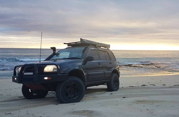 black suzuki grand vitara on beach at dusk australia off roading suzuki in perth, western australia