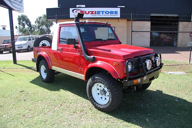 red ute rebuild parked on grass at 4wd part shop wa