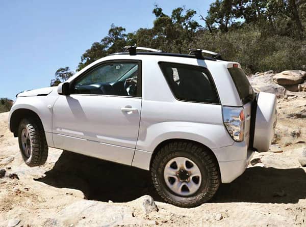 white suzuki grand vitara lift kit being tested on this white vitara off roading on a clear sky day in australia